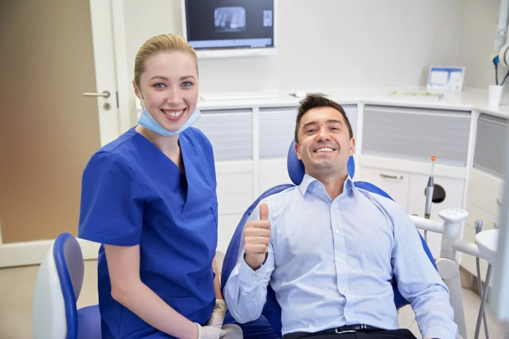 Dentist In Canton Mi Consulting Male Patient At Dental Clinic