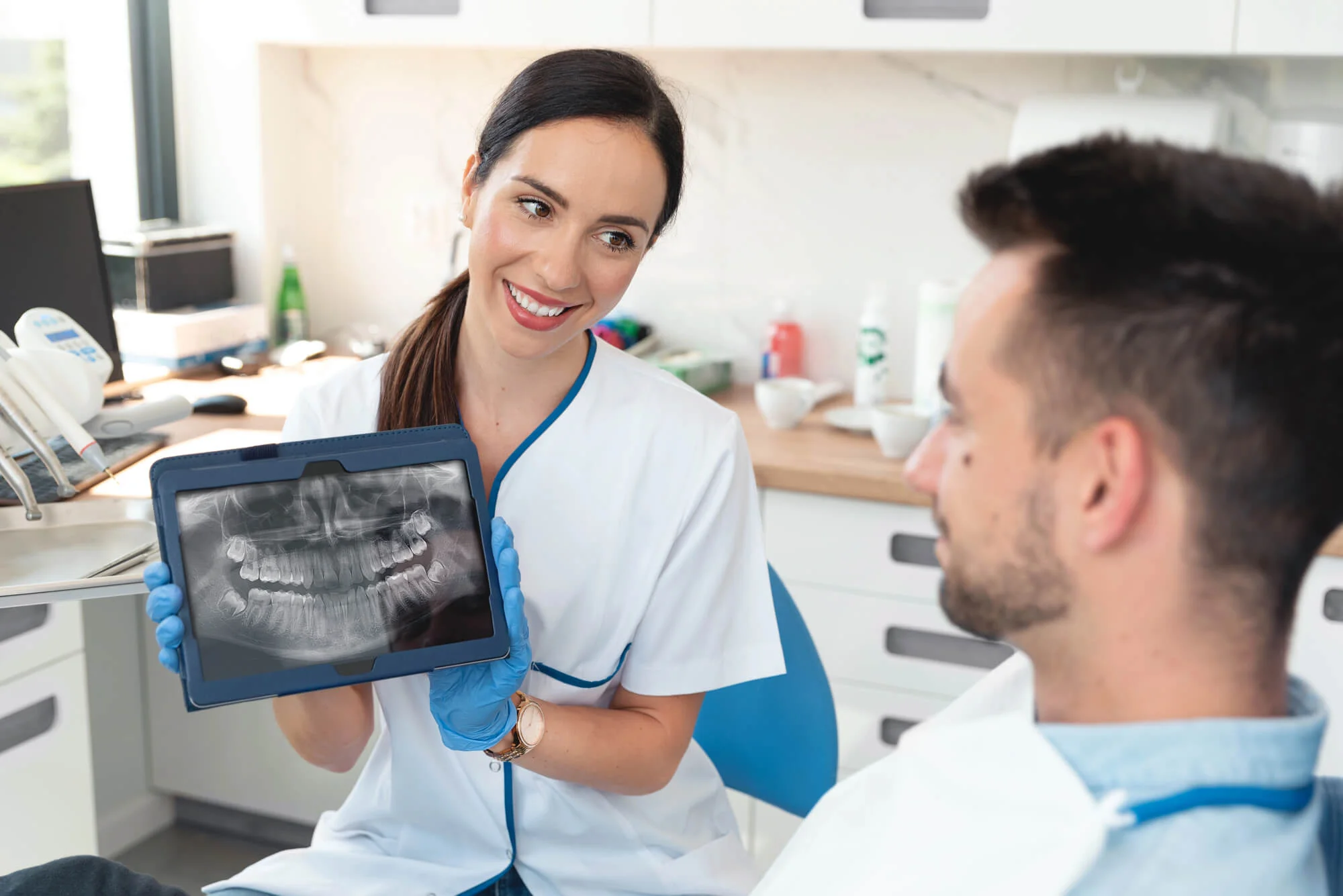 Dentist-In-Canton-Mi-Reviewing-Dental-X-Ray-On-Tablet-With-Patient