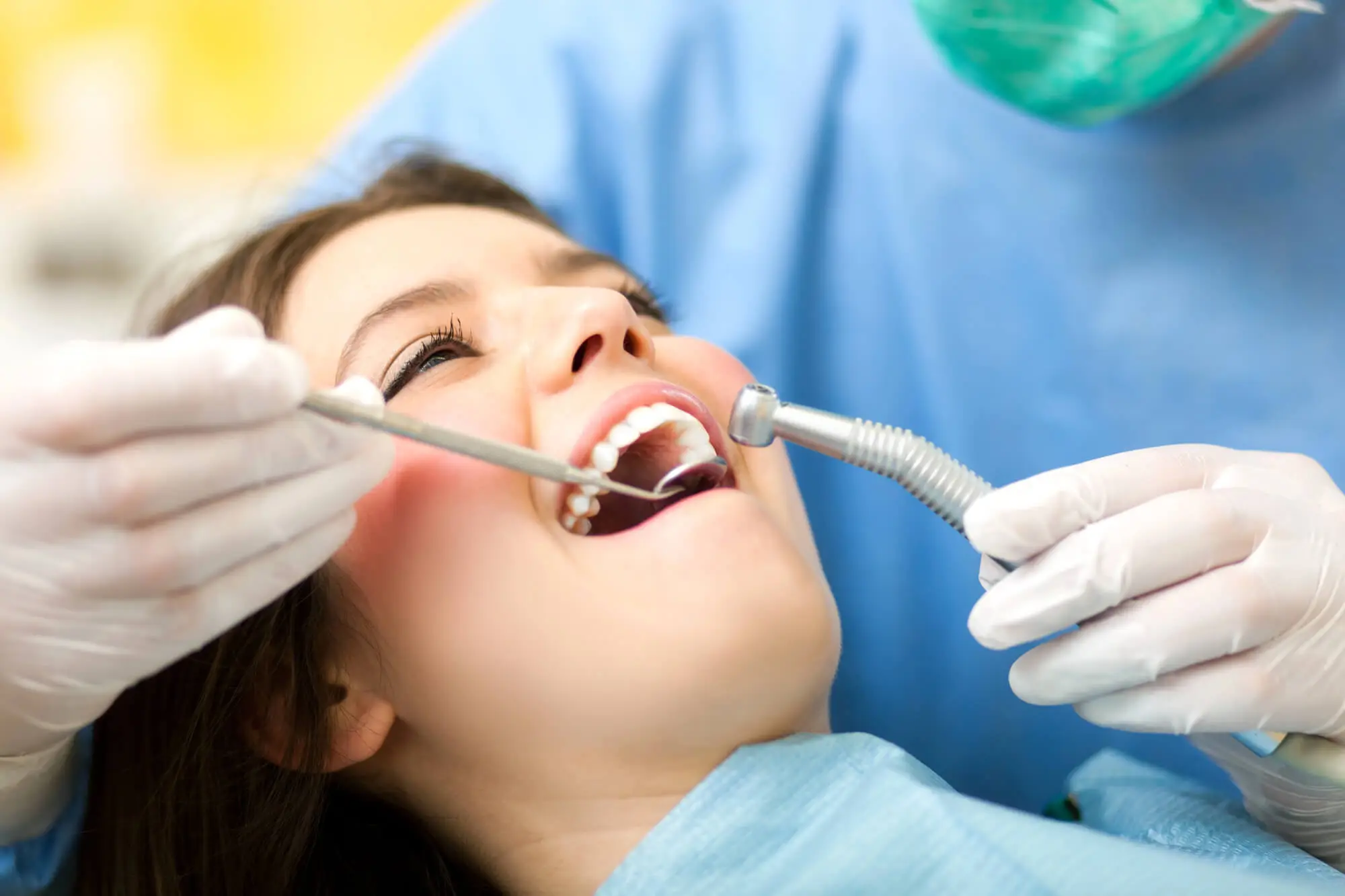 Dentist Applying A Full Mouth Restoration In Canton To A Female Patient