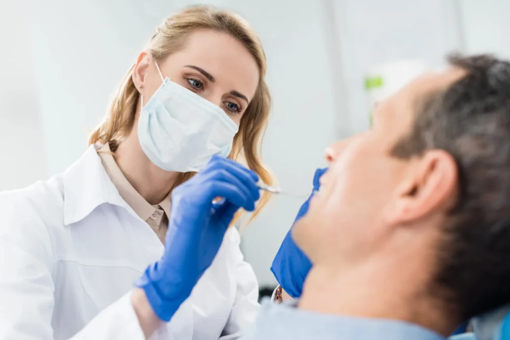 Dental Financing Canton Michigan Doctor Checking Teeth With Mirror