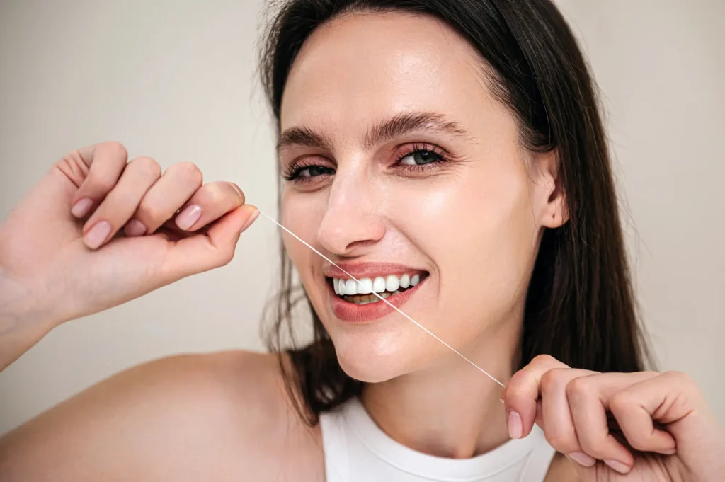 Smiling Woman Brushing Teeth After Gum Disease Treatment Canton Care