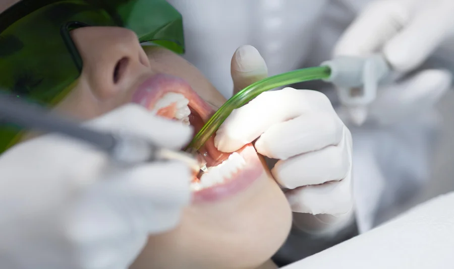 Dentist Using A Suction Tool During Dental Cleanings Canton Michigan